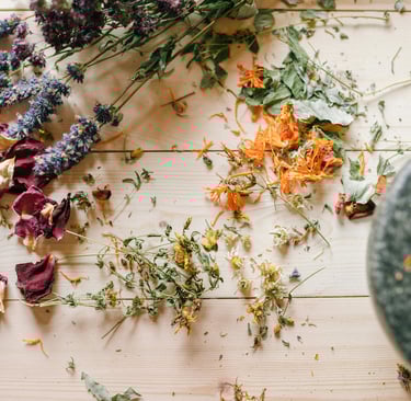 a picture of various flowers and herbs and a mortar