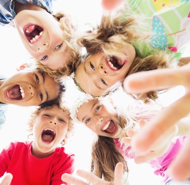 a group of children standing in a circle
