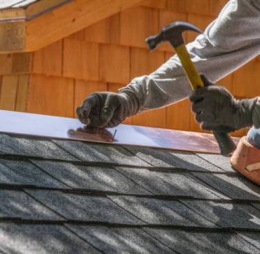 roofer hammering in nails