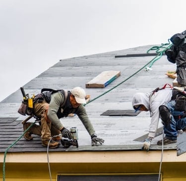 workers installing new roof tiles