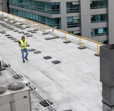 roofer doing an assessment of a commercial roof