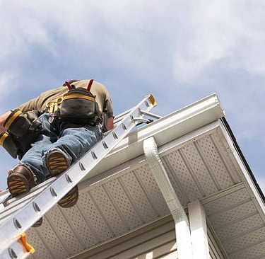 underside shot of a man going up a ladder