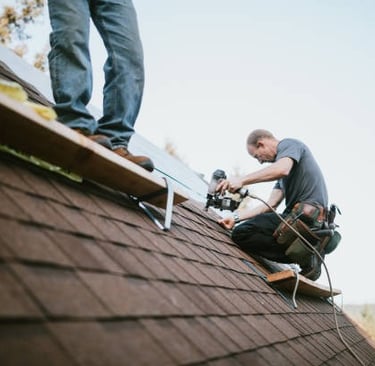workers installing a brown roof