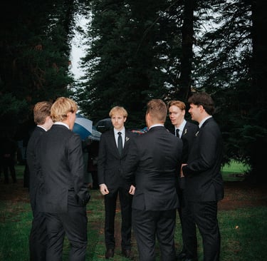 Groomsmen gathering beneath the pine trees before the ceremony at Adelaide Botanic Garden