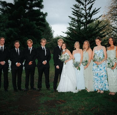 Bride and groom with their bridal party beneath the pine trees at Adelaide Botanic Garden