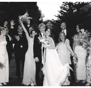 Bride and groom celebrating with their bridal party after the ceremony