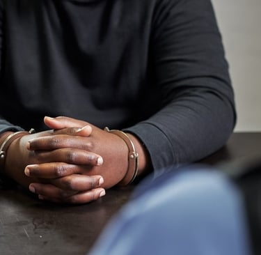 man in handcuffs at table