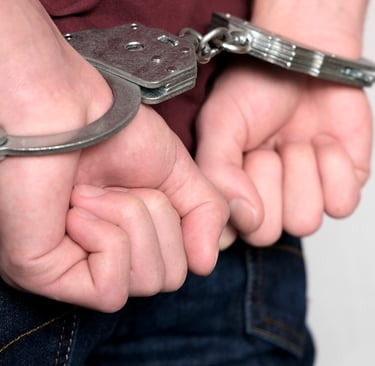 person in handcuffs making fists