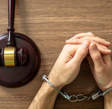 person in handcuffs in front of judge