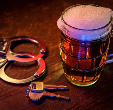 keys, handcuffs, and beer on table