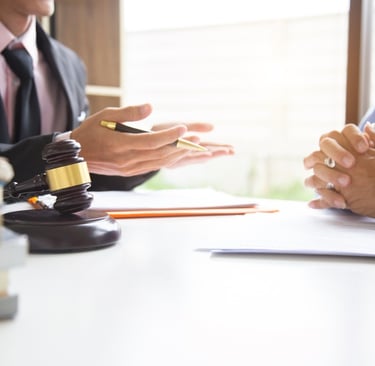 lawyer speaking to client at table
