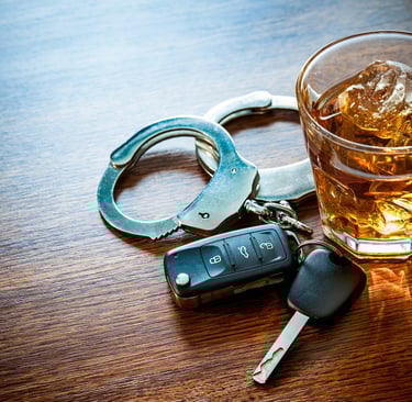 handcuffs, keys, and drink on table
