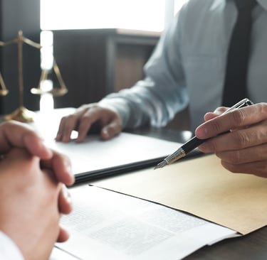 attorney meeting with client with paperwork
