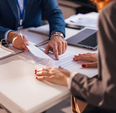 lawyer pointing to document for client
