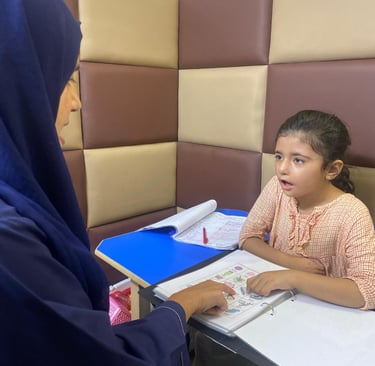 Therapist guiding young girl during session