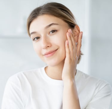 woman with clear skin touching own face