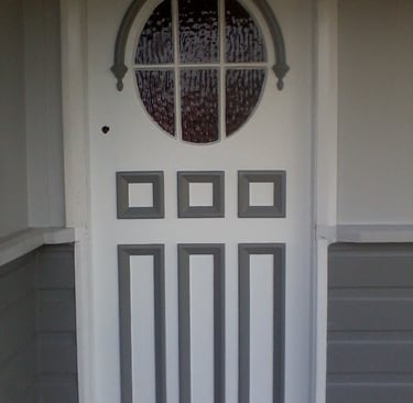 Freshly painted residential front door with grey trim detail