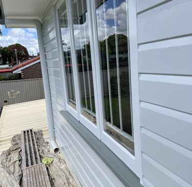 Freshly painted window frame and exterior wall after house repainting in Zillmere