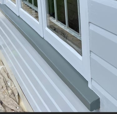 Finished exterior repaint showing clean window trim, sill and weatherboard detail