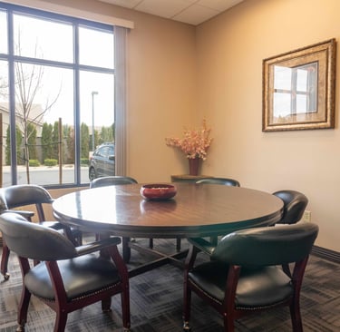 A conference room office table with a red bowl on it