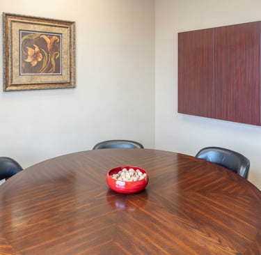 A bowl of walnuts on a table in a conference room