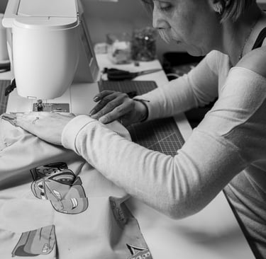 a woman is sewing an accessory on a sewing machine
