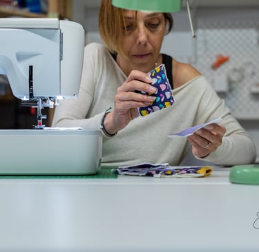 a woman is sewinging a piece of fabric