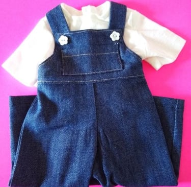 Handmade denim overalls and white T-shirt set for 18-inch dolls, displayed on a bright pink backgrou