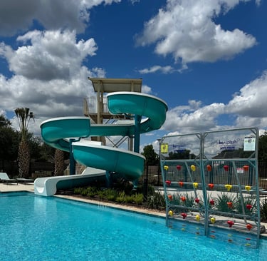 a water slider with a slider in the middle of a pool
