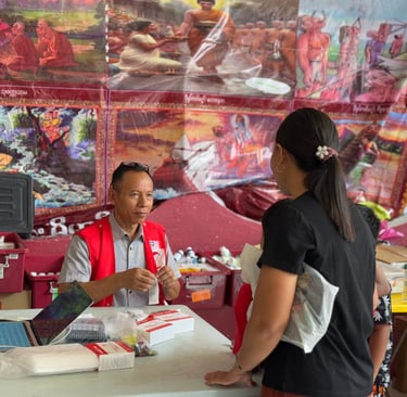 Nai Tun Tun is giving medicine to the patient