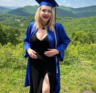 a woman in a graduation gown and a graduation cap