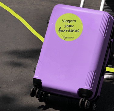 a person holding a suitcase with a yellow sticker on it