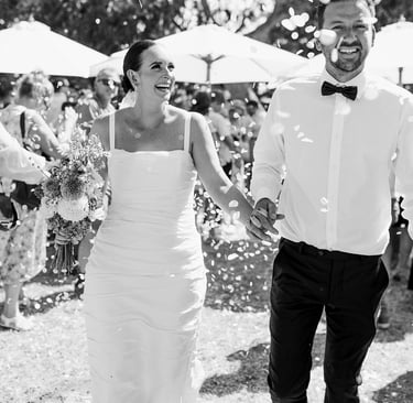 Newlyweds walk down the aisle at a Noosa beach wedding ceremony