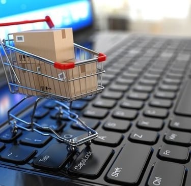 a shopping cartonce with a cartonce in front of a laptop