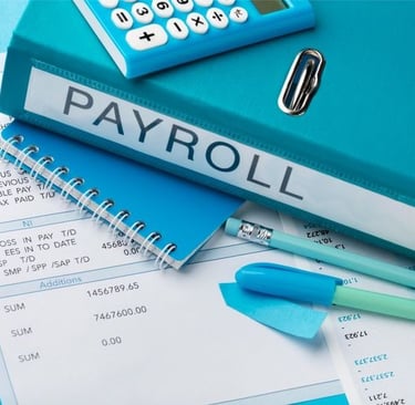 Payroll documents, calculator, and notebook on a desk representing employee salary management and accounting process.