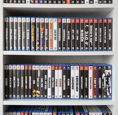 Stack of newly released video game boxes arranged neatly on a wooden table