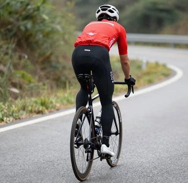 A scenic gravel bike trail winding through the rolling hills of Romagna under a clear blue sky