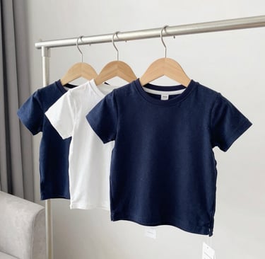 A neatly arranged display of various t-shirts in vivid colors on sleek hangers