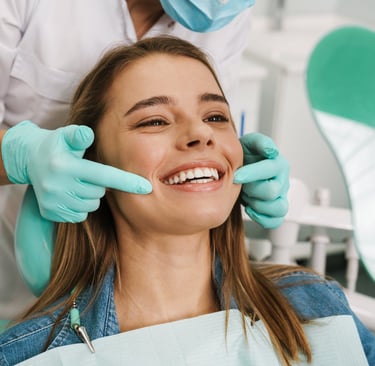 A dentist instructing a smiling woman.