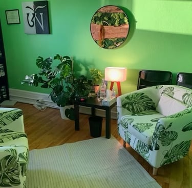 Therapy room at Village Healing Centre in Toronto with comfortable seating, plants and natural light