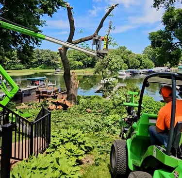 Professional arborists using a bucket lift on Lake Minnetonka.