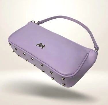 A stylish lavender leather baguette handbag with silver metal studs and a matching shoulder strap.