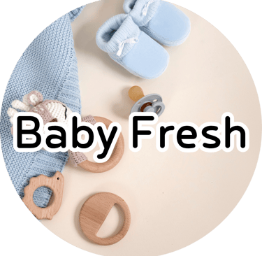Baby booties, knit blanket, and wooden teether with text reading "Baby Fresh." Soft nursery aesthetic.