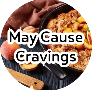 Warm peach cobbler in a skillet with fresh peaches and overlay text reading "May Cause Cravings."