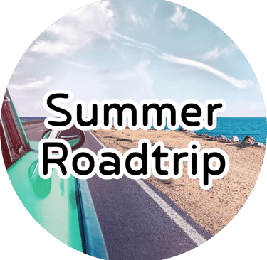 Coastal road and ocean seen from a vintage car window with text reading "Summer Roadtrip."
