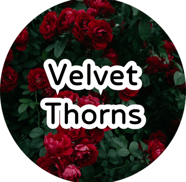 A lush, dramatic cluster of dark red roses blooming thickly with deep green leaves surrounding them.