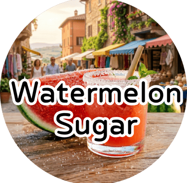 A sugar-rimmed watermelon drink with a straw next to a fresh watermelon slice, with a sunny European street behind.