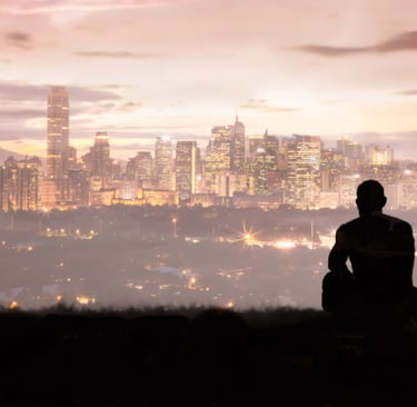 Image of mysterious man looking at the sun setting behind sky scrapers