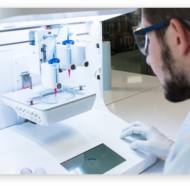 A scientist in a lab operating a 3D bioprinter to create tissue samples in a petri dish.
