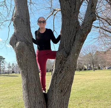 Zhenya climbs a tree. Caption: "Climbing toward your goals looks different for everyone!"